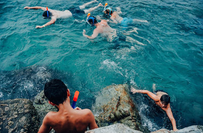 High angle view of men swimming in sea