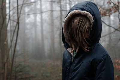 Close-up of woman standing in forest