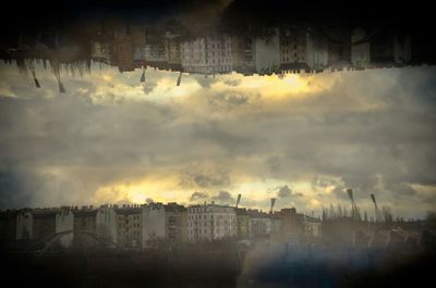 Buildings against cloudy sky