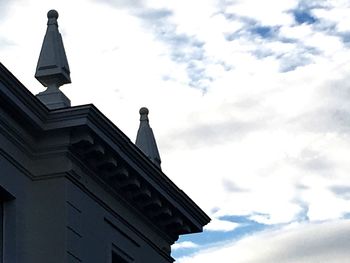 Low angle view of building against cloudy sky