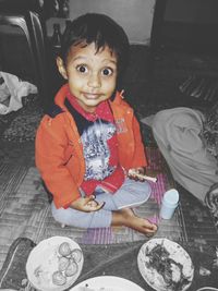 Portrait of cute girl sitting at home