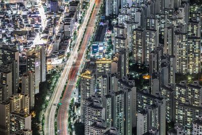 High angle view of city lit up at night