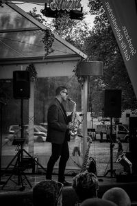 Full length of man standing on stage at music concert