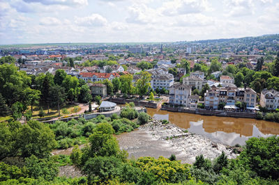 High angle view of river and cityscape against sky