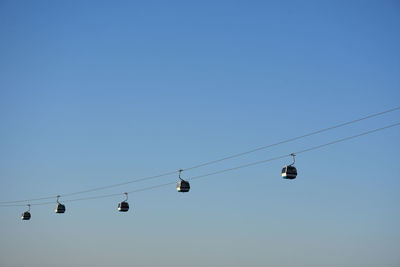 Low angle view of overhead cable against clear sky