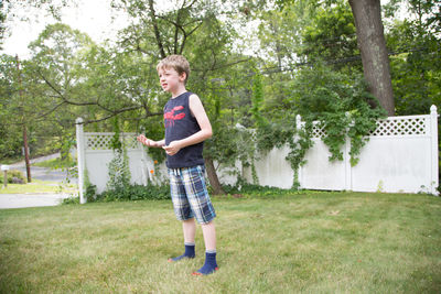 Full length of boy playing on grassy field