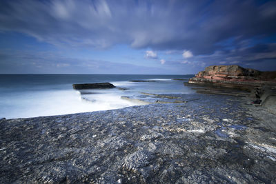 Scenic view of sea against cloudy sky