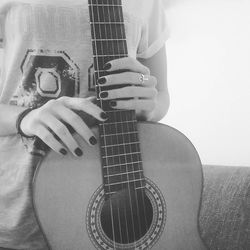 Close-up of man playing guitar