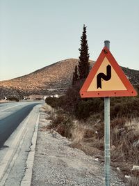 Road sign against clear sky