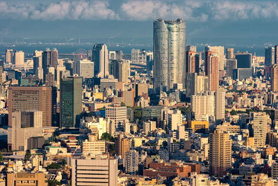 Aerial view of modern buildings in city against sky