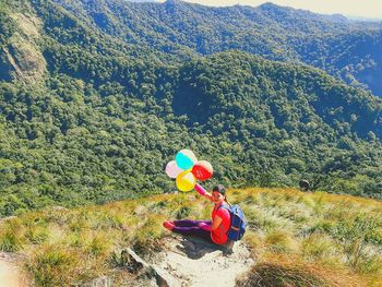 High angle view of people sitting on mountain