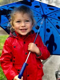 Portrait of cute girl holding umbrella