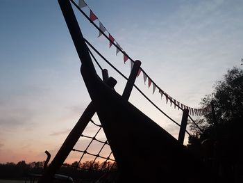 Low angle view of silhouette bridge against sky during sunset