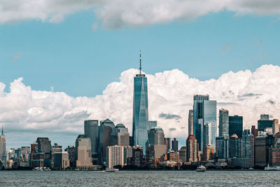 Modern buildings in city against cloudy sky