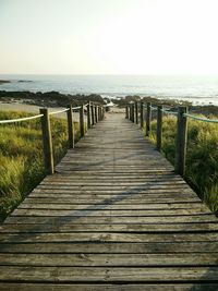 Pier over sea against clear sky