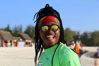 Portrait of smiling man against sky