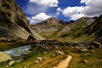 Scenic view of river amidst mountains against sky