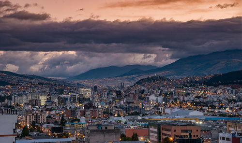 Aerial view of townscape against sky at sunset