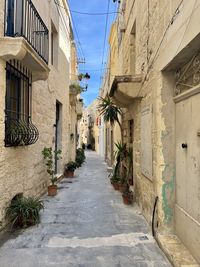 Footpath amidst buildings in city