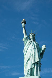 Low angle view of statue against blue sky