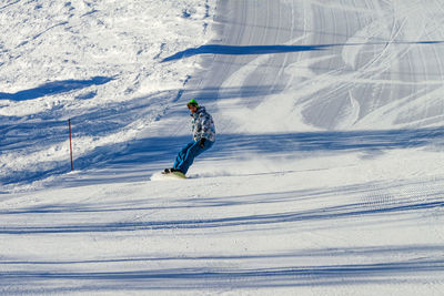 Man skiing on snow covered field