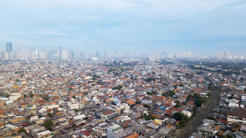 High angle view of city buildings against sky