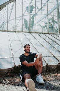 Portrait of young man sitting outdoors