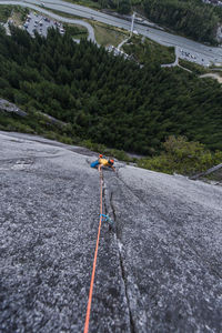 Man rock climbing cracks in granite very exposed in squamish chief