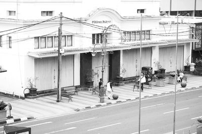 Street light on road by building in city