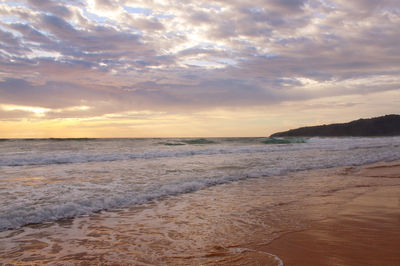 Scenic view of beach against sky during sunset