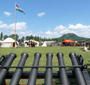 Group of people on field against the sky