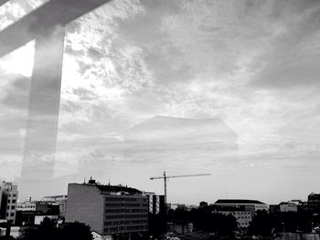 Buildings against cloudy sky