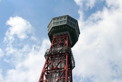 Low angle view of tower against cloudy sky