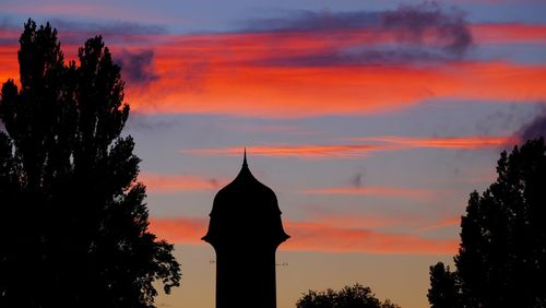 Silhouette temple against sky during sunset