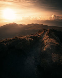 Aerial view of silhouette landscape against sky during sunset