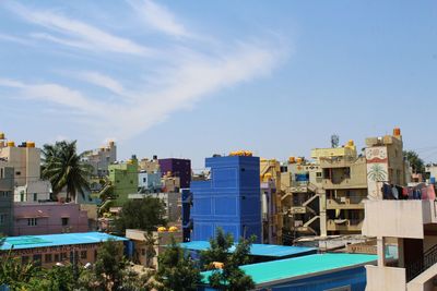 Buildings in city against blue sky