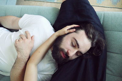 Young man sleeping on bed at home