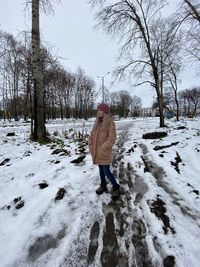 Rear view of man standing on snow covered land