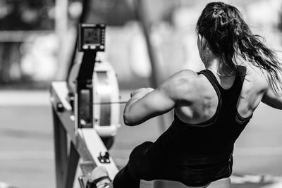 Rear view of athlete exercising on equipment