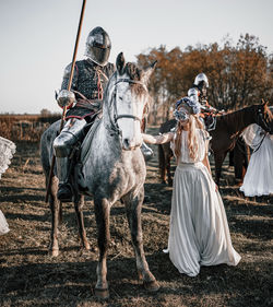 People riding horses on field