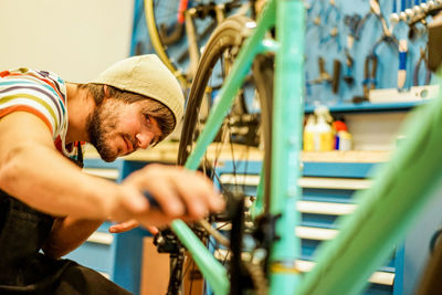 Man repairing bicycle at workshop