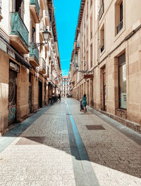 Street amidst buildings in city against sky