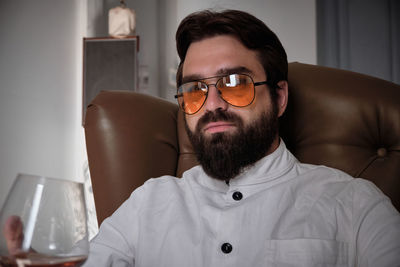 Portrait of young man sitting at home