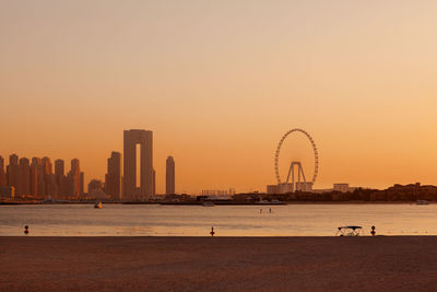 Sunset over the island of blue waters with the famous dubai eye ferris wheel