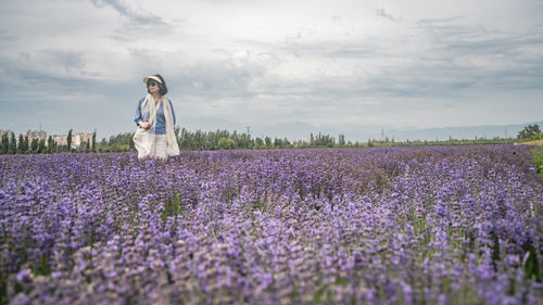 Rear view of woman standing on field