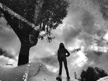 Reflection of people standing in puddle