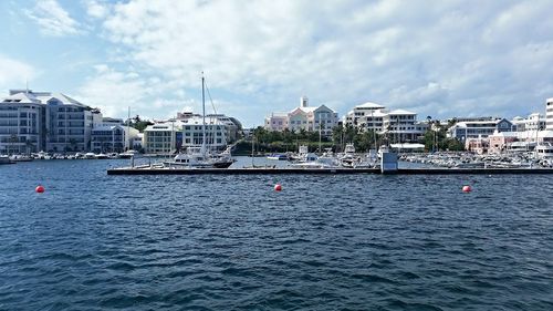 Boats in river with city in background