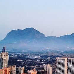 Cityscape with mountain range in background