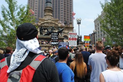 Crowd in city against sky