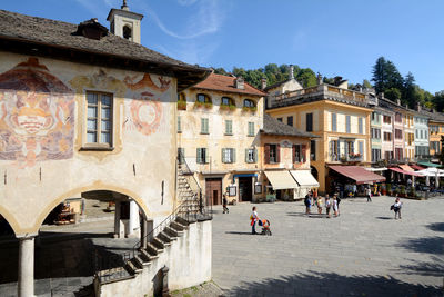 People on street by buildings in town